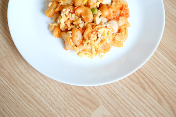 macaroni pasta in tomato sauce on a wooden table