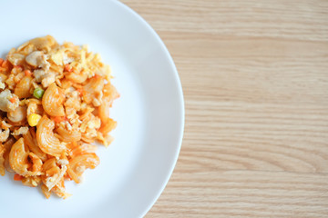 macaroni pasta in tomato sauce on a wooden table