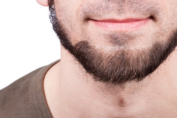 Obraz premium Close-up of young bearded man standing against white background