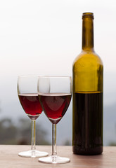 Red wine in glasses with bottle, outdoor