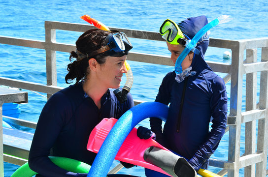 Mother and daughter prepare to snorkeling dive