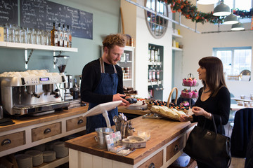  Female Customer Paying In Coffee Shop	