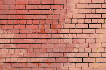 Red brick wall as background front view closeup