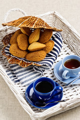 Breakfast. French pastries madeleines with cup of coffee.