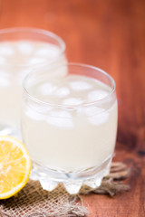 Ginger drink with ice and a lemon