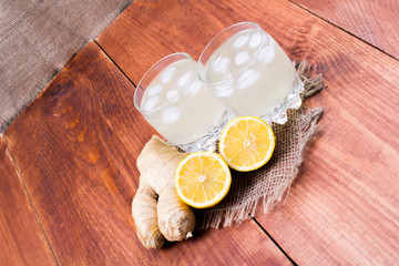 Ginger drink with ice and a lemon