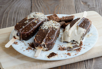 Chocolate popsicles on a wood background, selective focus