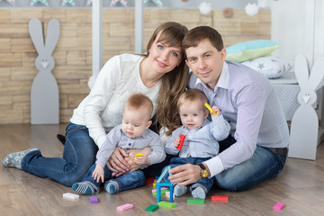 Happy young family are built of wooden planks house