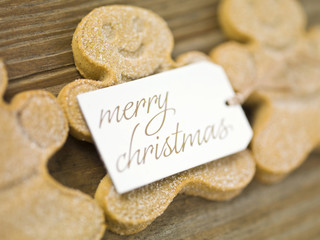 gingerbread candies and merry christmas placard.