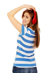 Teenage woman listening to music