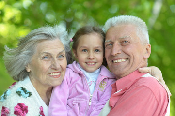 grandparents smiling with granddaughter