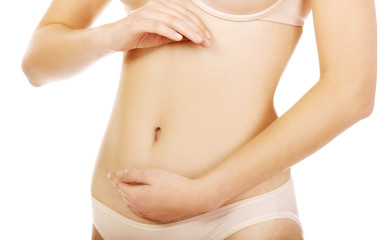 Young woman belly with hand on it