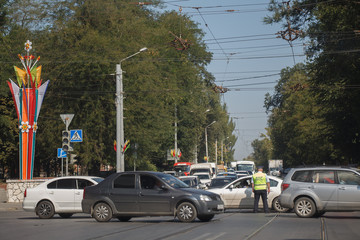 Road traffic controller regulates traffic on crossroads with broken traffic lights