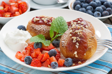 sweet cheese pancakes with berries and cream for breakfast