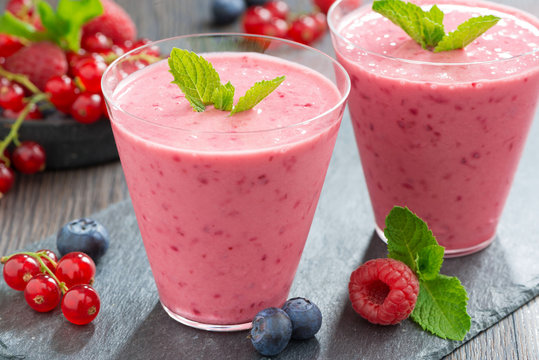 milkshake with fresh berries and mint in glass