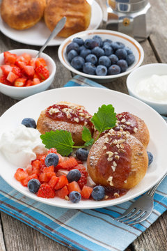 sweet cheese pancakes with berries and cream, vertical