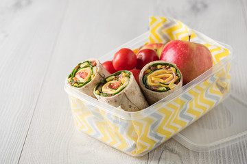 Ham and cheese wraps in lunch box © 3532studio
