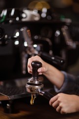 Fototapeta na wymiar Close up of barista preparing coffee with machine