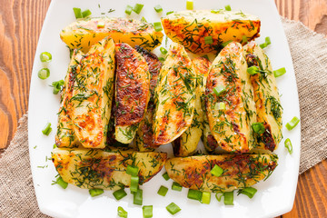 fried potatoes with dill and onion on a white plate