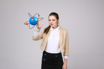 Woman scientist with atom model, research concept