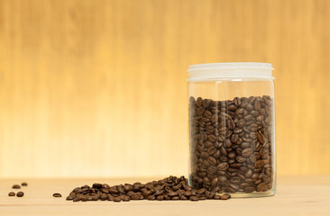 coffee bean in the glass jar on table wood