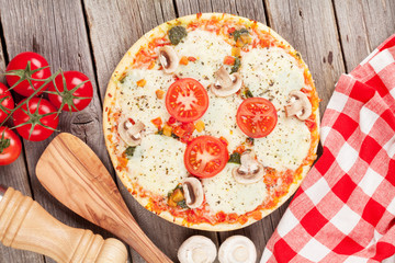 Pizza with tomatoes and mushrooms