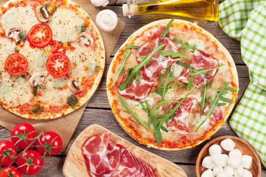 Pizza with prosciutto, tomatoes and mushrooms