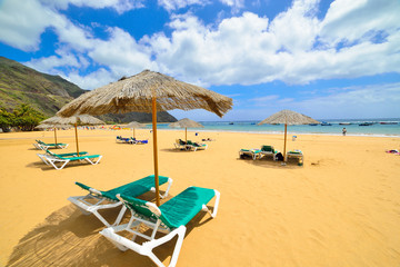 Umbrella and chairs on Las Teresitas beach, in Tenerife island, Spain