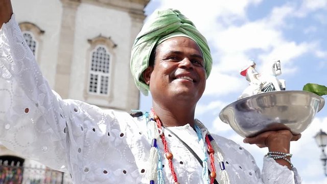 Brazilian man wearing traditional clothes at Bonfim Church in Salvador, Bahia, Brazil