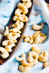 raw cashew nuts in a wooden platter
