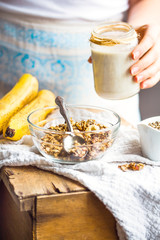 jar of hemp seed milk, hold in your hand, a healthy breakfast