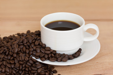 Coffee cup and coffee beans on table