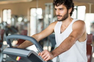 Fototapeta na wymiar Man working out on a treadmill