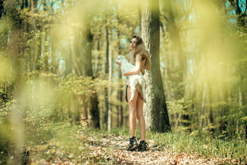 Young girl with goat in forest