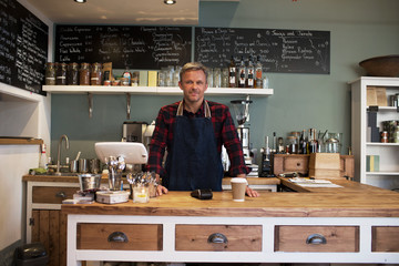  Portrait Of Owner Standing In Coffee Shop	