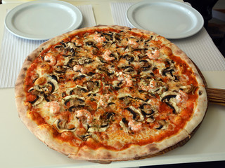 Fresh Italian pizza with cheese, mushroom and  prawns