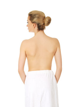 Young topless woman back after spa or bath.
