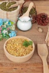 Soy beans and dry beans on wood background.