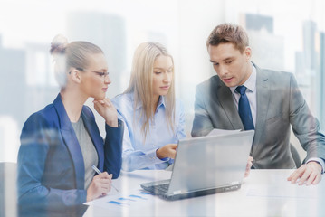 business team with laptop having discussion