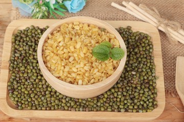 Soy beans and dry beans on wood background.