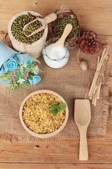 Soy beans and dry beans on wood background.