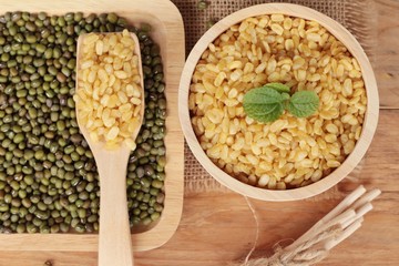 Soy beans and dry beans on wood background.