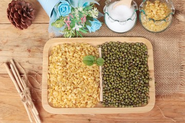 Soy beans and dry beans on wood background.