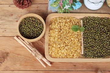 Soy beans and dry beans on wood background.