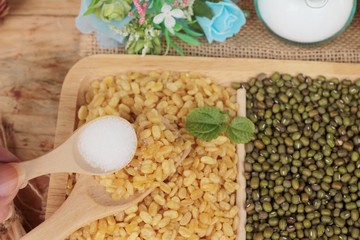 Soy beans and dry beans on wood background.
