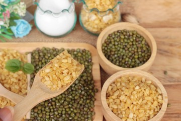 Soy beans and dry beans on wood background.