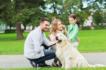 happy family with labrador retriever dog in park