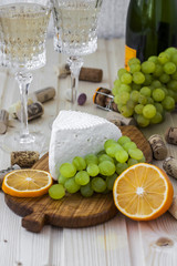 cheese with grapes and a glass of champagne