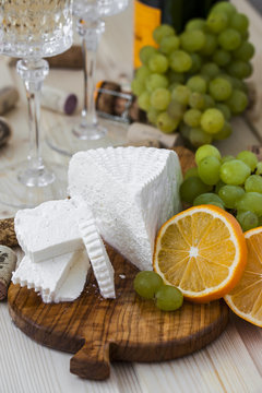 cheese with grapes and a glass of champagne