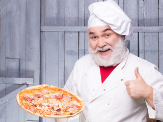 Bearded cook with pizza